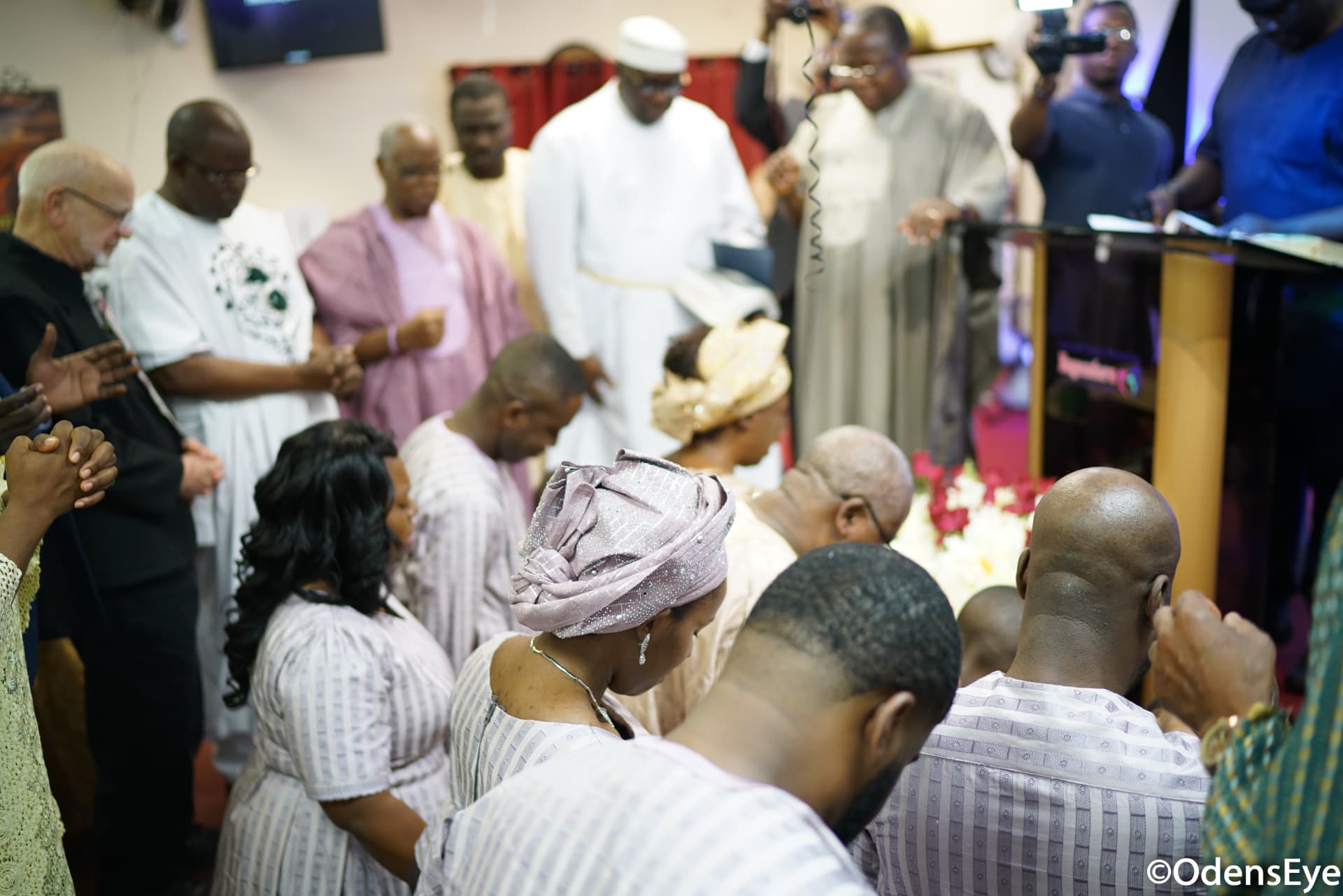 Family and ministers gathered in prayer at the celebration