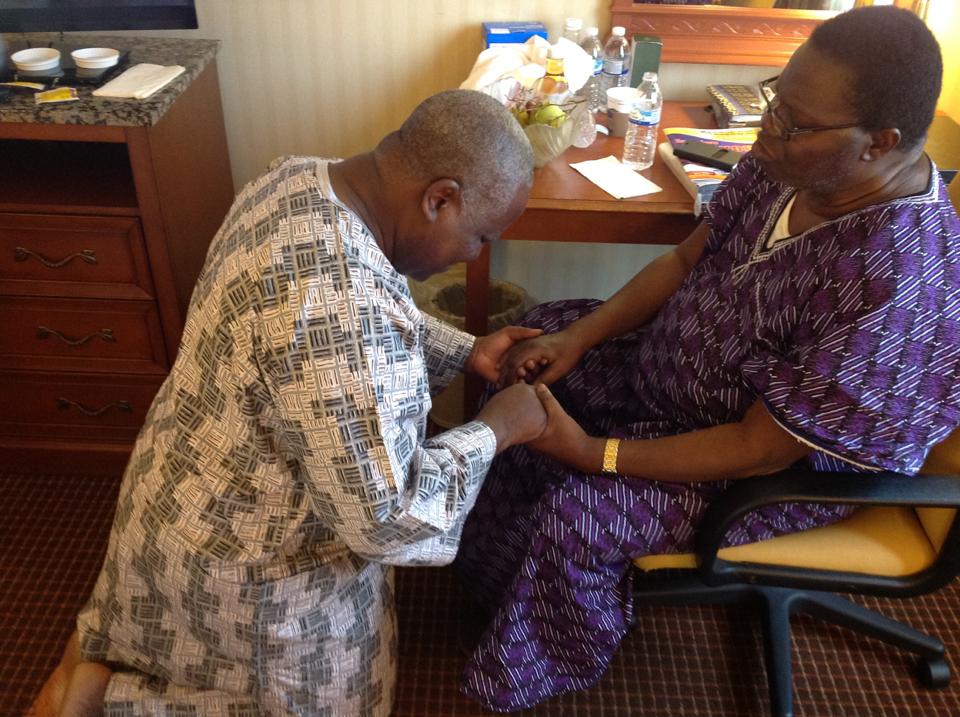 Apostle Odeneye in a quiet moment of prayer with an elder